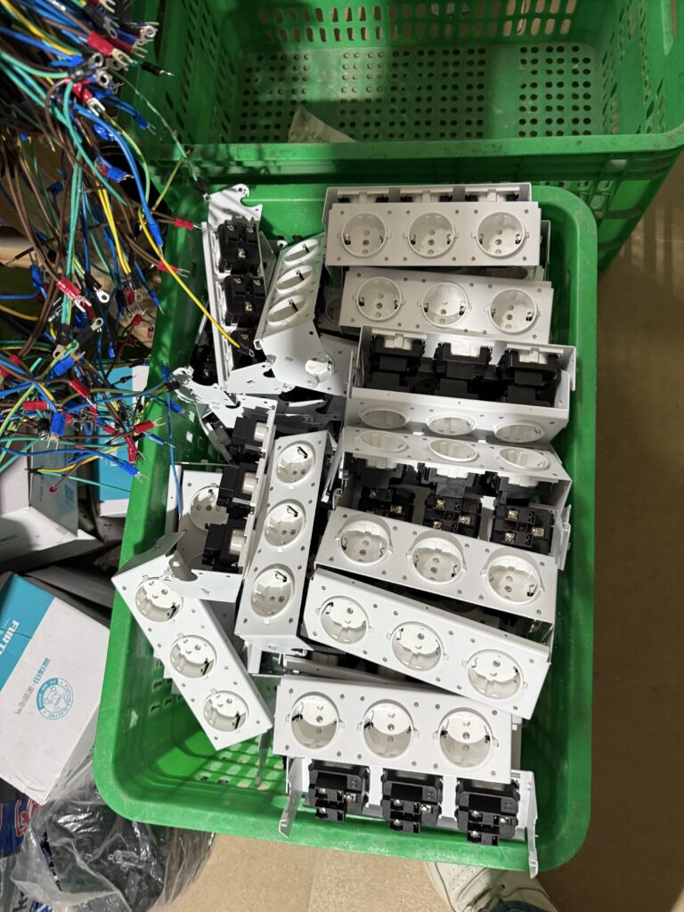 Workers assembling pop-up desktop sockets on professional production line at Moonian manufacturing facility